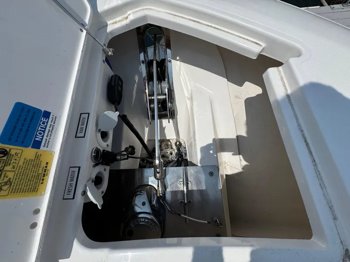  Yacht Photos Pics 2022 Pursuit S 378 Sport boat anchor compartment with winch and control panel.