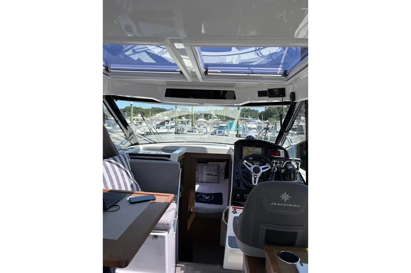  Yacht Photos Pics Interior view of 2020 Jeanneau NC 895 boat with helm and seating area.