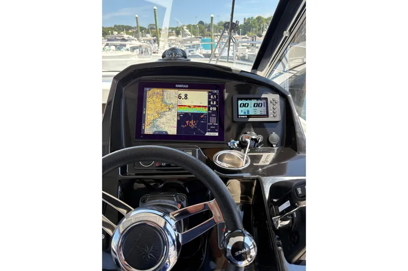  Yacht Photos Pics Cockpit view of 2020 Jeanneau NC 895 with navigation displays and steering wheel.