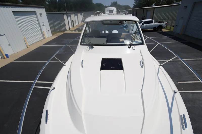  Yacht Photos Pics 2021 Pursuit OS 325 Offshore boat docked in a marina parking area.