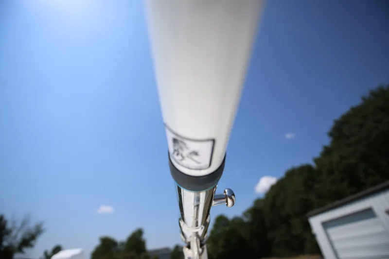  Yacht Photos Pics Close-up of a 2021 Pursuit OS 325 Offshore boat component against a clear blue sky.