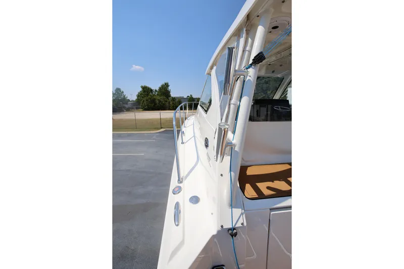  Yacht Photos Pics 2021 Pursuit OS 325 Offshore boat side view with railing and clear sky.