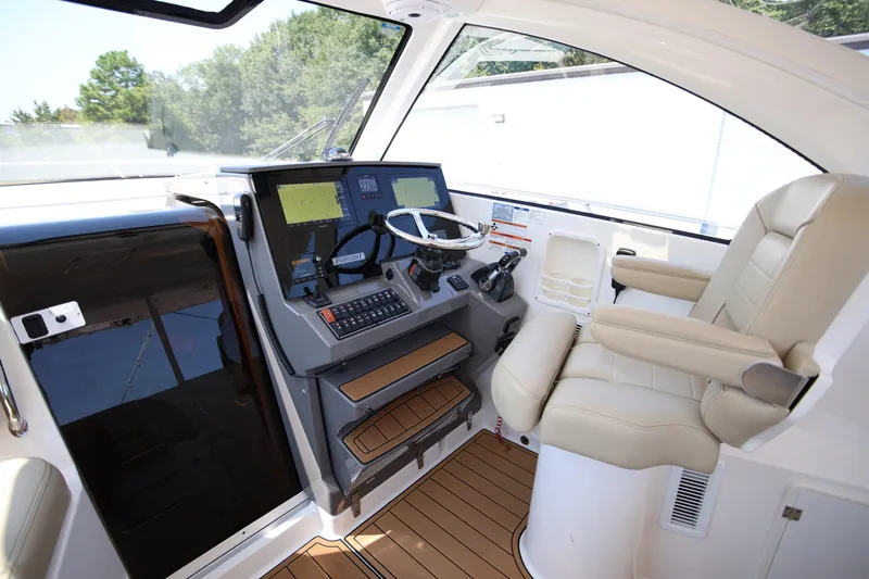  Yacht Photos Pics 2021 Pursuit OS 325 Offshore boat cockpit with modern controls and comfortable seating.