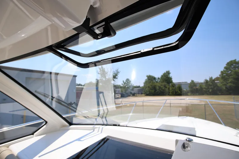  Yacht Photos Pics 2021 Pursuit OS 325 Offshore boat interior with open window, showcasing clear sky view.