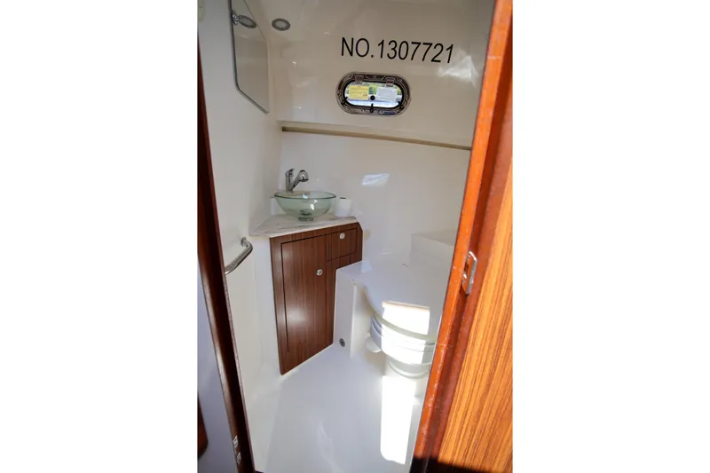  Yacht Photos Pics 2021 Pursuit OS 325 Offshore boat bathroom with sink and toilet.