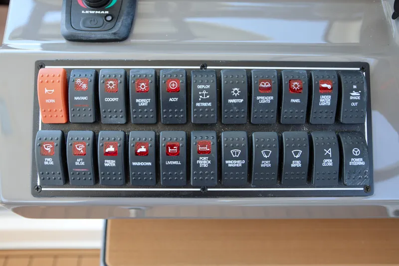  Yacht Photos Pics Control panel of a 2021 Pursuit OS 325 Offshore boat with labeled switches.