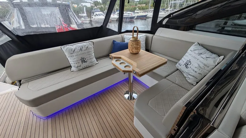 In Stock Yacht Photos Pics Luxurious seating area on 2025 Fairline Targa 45 GT yacht with elegant cushions and table.