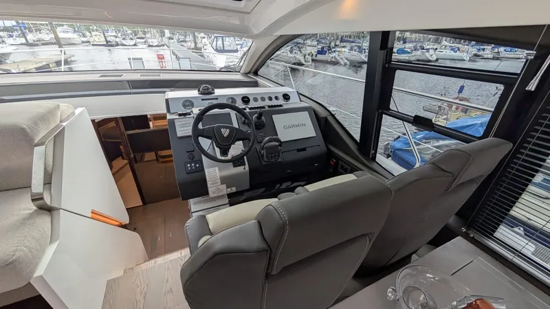 In Stock Yacht Photos Pics 2025 Fairline Targa 45 GT helm with Garmin navigation, overlooking marina.