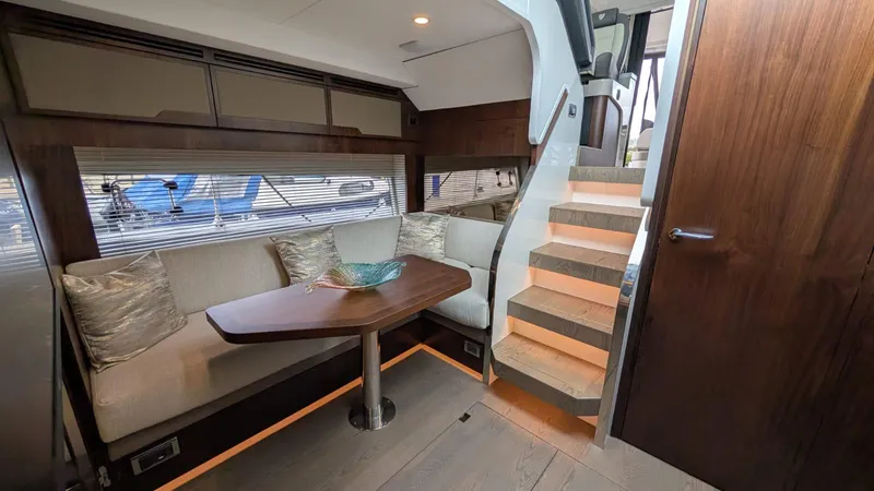 In Stock Yacht Photos Pics Luxurious interior of 2025 Fairline Targa 45 GT yacht with elegant seating and staircase.