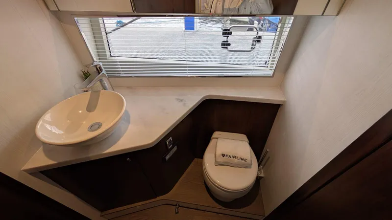 In Stock Yacht Photos Pics 2025 Fairline Targa 45 GT bathroom with modern sink and toilet, featuring sleek design.