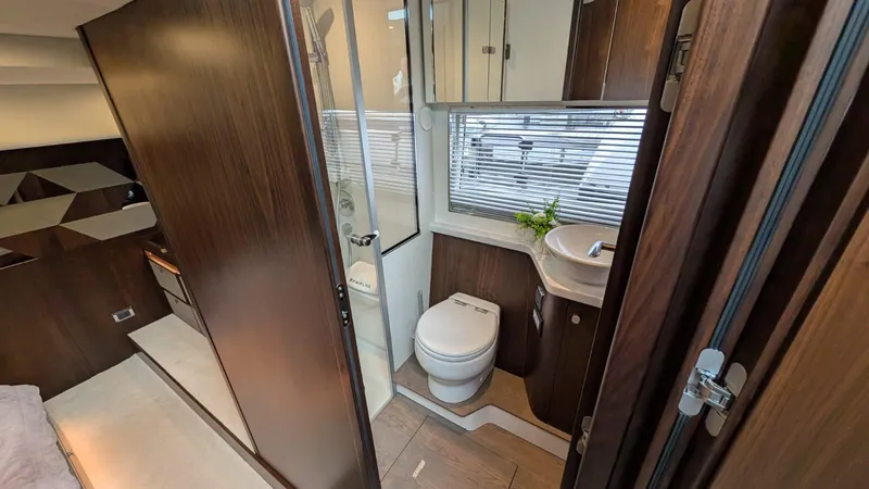 In Stock Yacht Photos Pics Luxurious bathroom interior of 2025 Fairline Targa 45 GT yacht, featuring modern fixtures and wood accents.