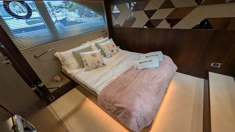 In Stock Yacht Photos Pics Luxurious bedroom interior of 2025 Fairline Targa 45 GT yacht with elegant bedding.