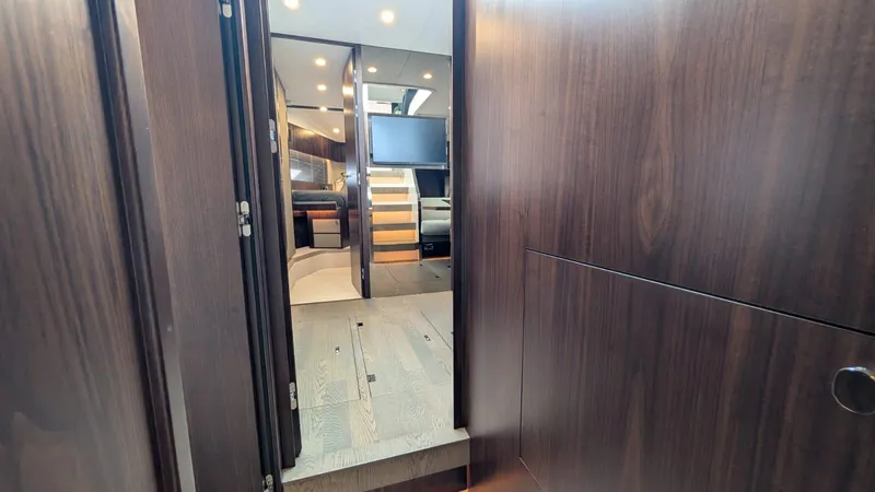 In Stock Yacht Photos Pics Interior view of 2025 Fairline Targa 45 GT yacht, featuring sleek wood paneling and modern design.