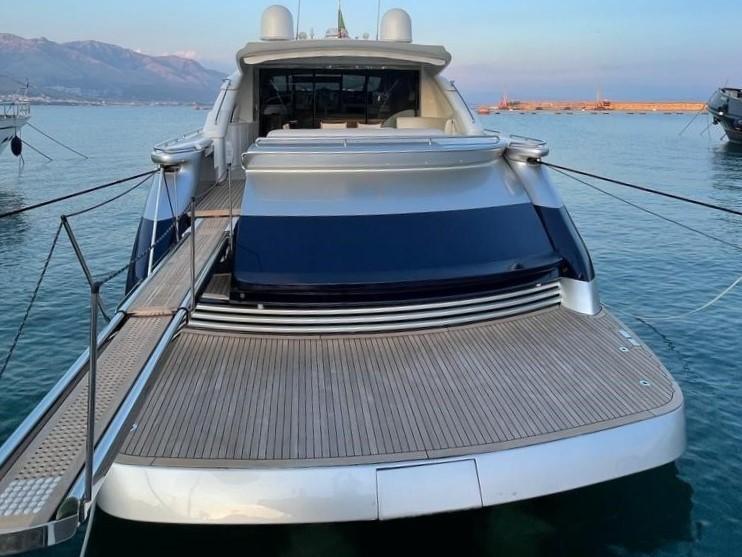 Luxury 2005 Pershing 76 yacht docked, showcasing sleek design and spacious deck.