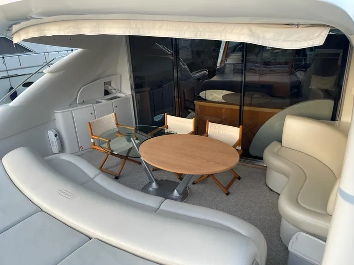  Yacht Photos Pics Luxury seating area on a 2005 Pershing 76 yacht with round table and chairs.