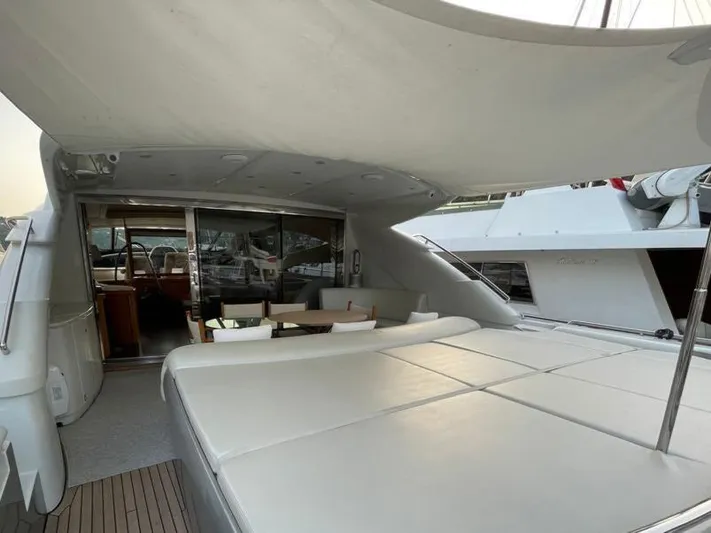  Yacht Photos Pics Luxurious 2005 Pershing 76 yacht deck with seating and sunbathing area.