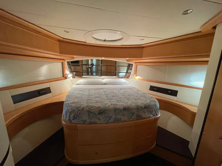  Yacht Photos Pics Luxurious cabin interior of a 2005 Pershing 76 yacht with elegant wood finishes.