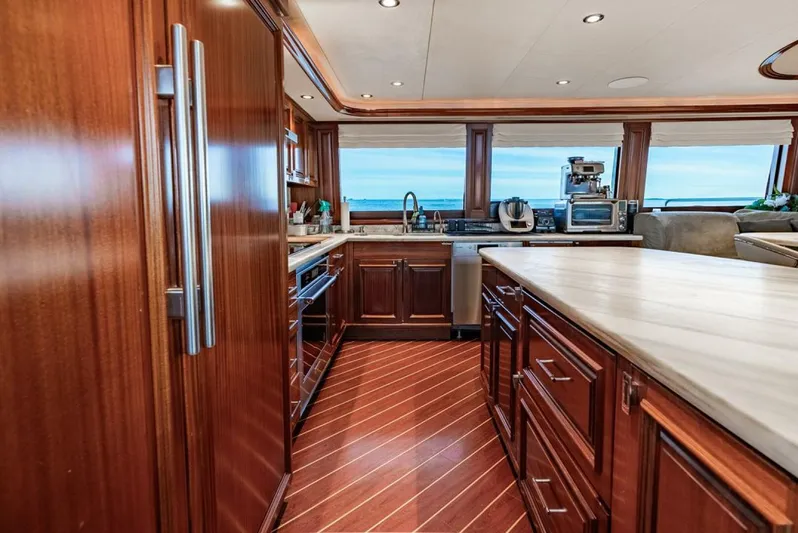 Simplicity Yacht Photos Pics Luxurious kitchen interior of 2012 Westport 112 yacht with wooden cabinetry and ocean view.