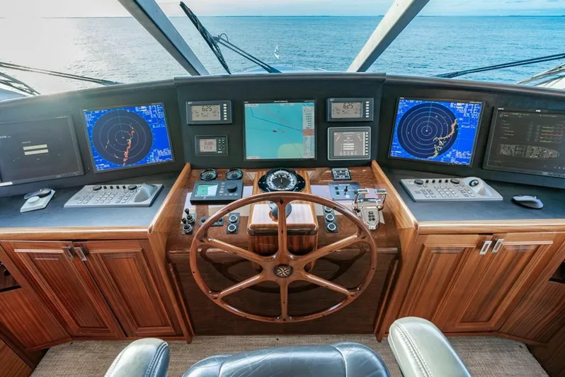 Simplicity Yacht Photos Pics Helm of 2012 Westport 112 yacht with navigation screens and wooden steering wheel.