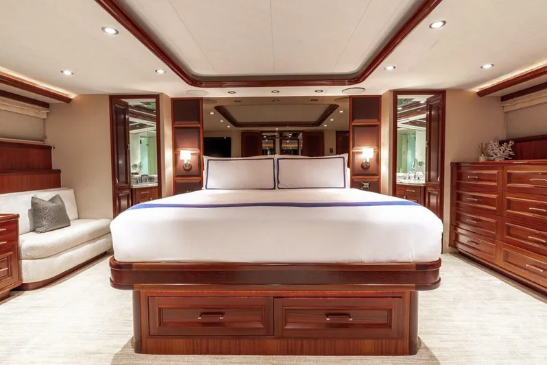 Simplicity Yacht Photos Pics Luxurious bedroom interior on 2012 Westport 112 yacht, featuring elegant wood finishes and spacious design.
