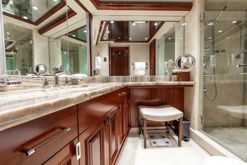 Simplicity Yacht Photos Pics Luxurious bathroom in 2012 Westport 112 yacht with elegant wood cabinetry and glass shower.
