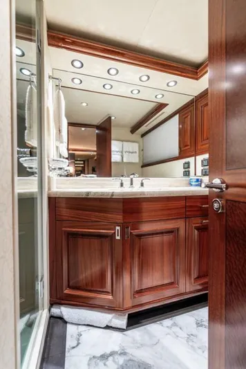 Simplicity Yacht Photos Pics Luxurious bathroom interior on a 2012 Westport 112 yacht, featuring elegant wood cabinetry and marble flooring.