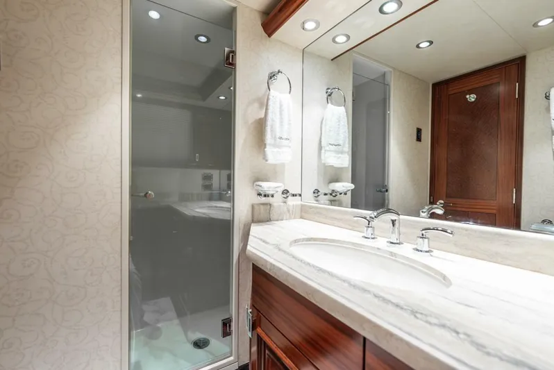 Simplicity Yacht Photos Pics Luxurious bathroom in 2012 Westport 112 yacht, featuring elegant fixtures and a glass-enclosed shower.