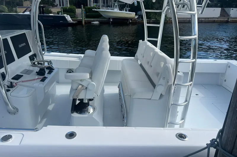 Yacht Photos Pics 2025 Contender 44 ST boat interior with white seating and navigation equipment.