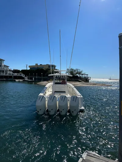 Seaglass Yacht Photos Pics 2022 SeaVee 390B boat with four engines docked in sunny waterfront setting.