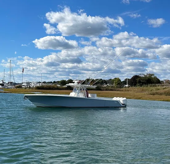 Seaglass Yacht Photos Pics 2022 SeaVee 390B boat on calm water under a blue sky with clouds.
