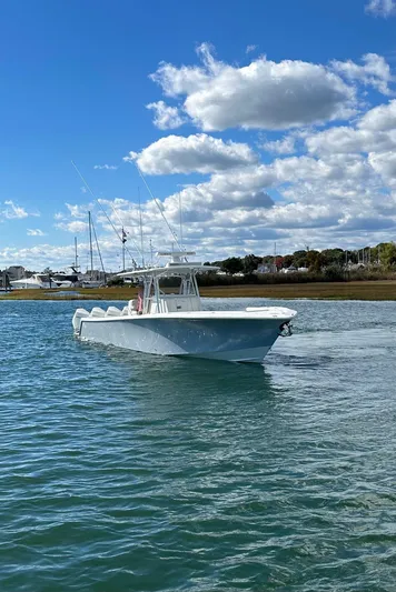 Seaglass Yacht Photos Pics 2022 SeaVee 390B boat cruising on a sunny day with blue skies and clouds.