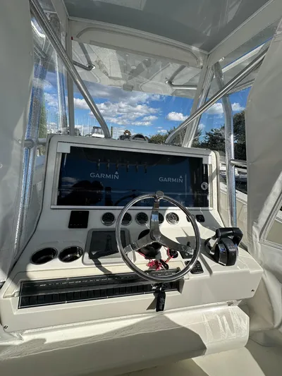 Seaglass Yacht Photos Pics 2022 SeaVee 390B boat helm with Garmin navigation system and steering wheel.