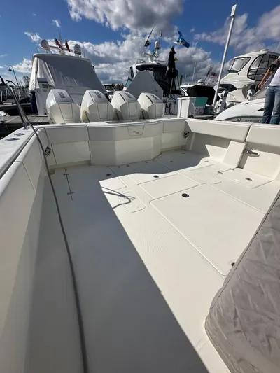 Seaglass Yacht Photos Pics 2022 SeaVee 390B boat deck with multiple outboard engines, docked under a cloudy sky.