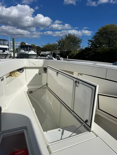 Seaglass Yacht Photos Pics 2022 SeaVee 390B boat with open storage compartment under clear blue sky.