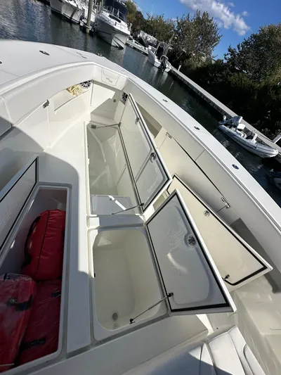 Seaglass Yacht Photos Pics 2022 SeaVee 390B boat with open storage compartments, docked in a marina.