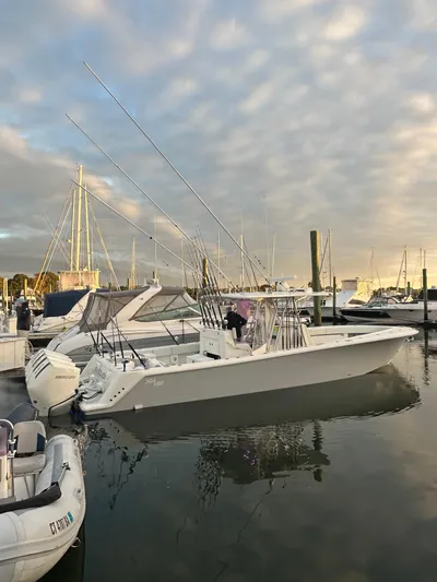 Seaglass Yacht Photos Pics 2022 SeaVee 390B boat docked at marina with fishing rods and calm water.