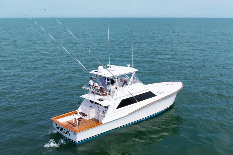 Spiros Yacht Photos Pics 1972 Jim Smith Custom Convertible boat cruising on open sea with fishing rods.