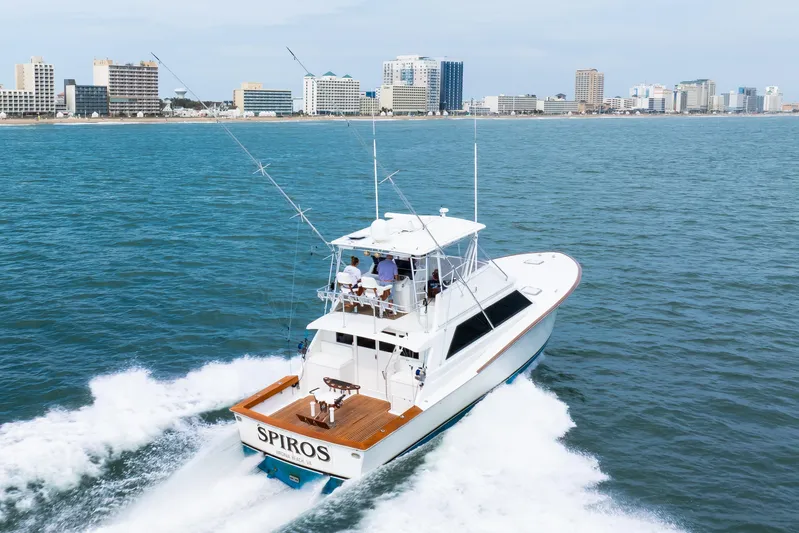 Spiros Yacht Photos Pics A 1972 Jim Smith Custom Convertible yacht cruising near a city skyline.