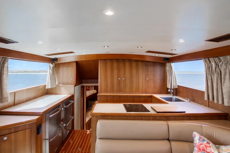 Spiros Yacht Photos Pics Luxurious 1972 Jim Smith Custom Convertible yacht interior with modern kitchen and ocean view.