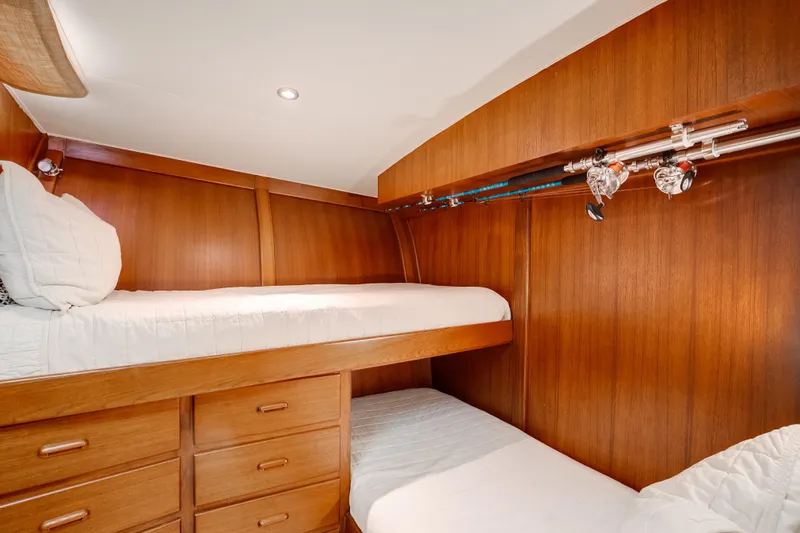 Spiros Yacht Photos Pics 1972 Jim Smith Custom Convertible interior with wooden bunk beds and fishing rods.