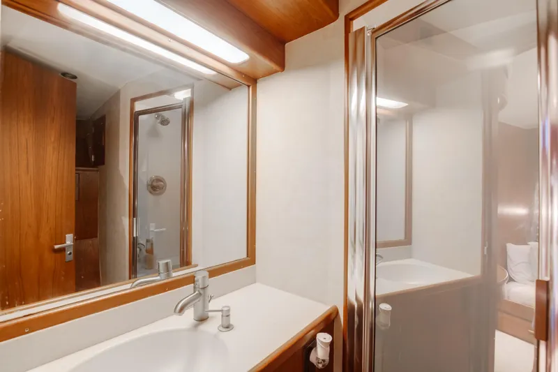 Spiros Yacht Photos Pics Bathroom interior of 1972 Jim Smith Custom Convertible yacht, featuring wood accents and modern fixtures.