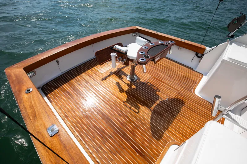 Spiros Yacht Photos Pics 1972 Jim Smith Custom Convertible boat deck with polished wood finish and fishing chair.