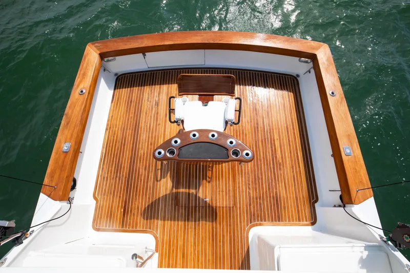 Spiros Yacht Photos Pics 1972 Jim Smith Custom Convertible boat deck with polished wood finish and fishing chair.