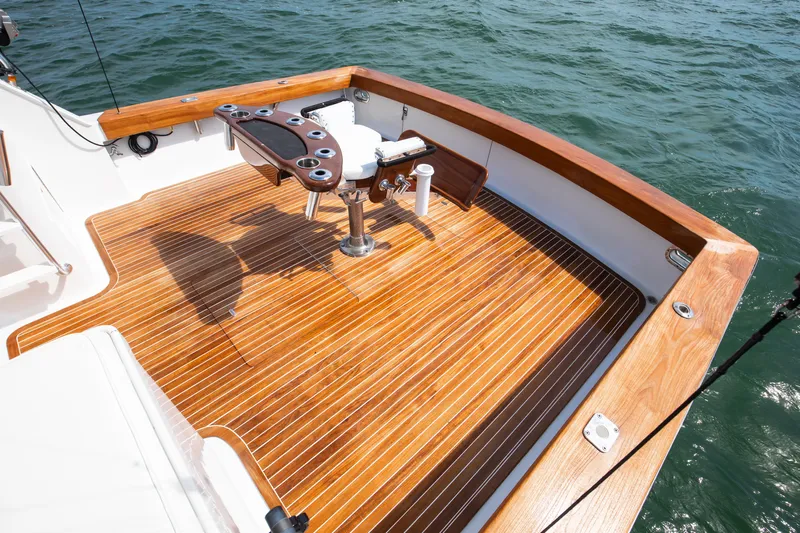 Spiros Yacht Photos Pics 1972 Jim Smith Custom Convertible boat deck with polished wood finish and fishing chair.