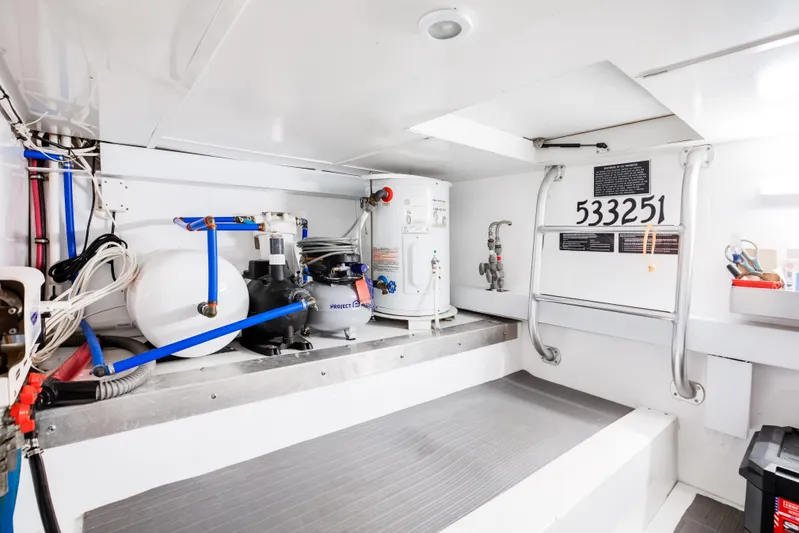 Spiros Yacht Photos Pics Engine room of 1972 Jim Smith Custom Convertible with equipment and maintenance tools.