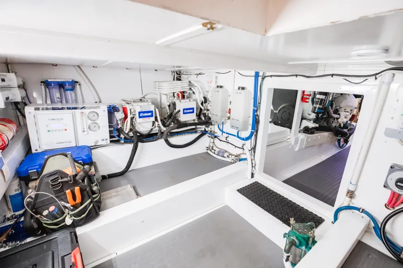 Spiros Yacht Photos Pics Engine room of 1972 Jim Smith Custom Convertible with modern equipment and tools.