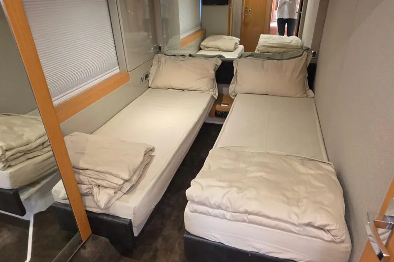  Yacht Photos Pics Twin beds in a cozy cabin of a 2013 Fairline Targa 62 GT yacht.