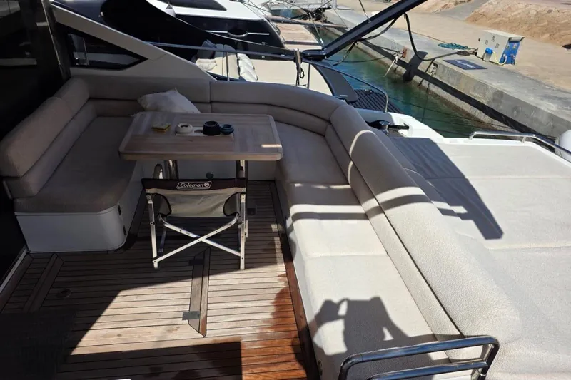 Yacht Photos Pics Luxurious 2013 Fairline Targa 62 GT yacht deck with cushioned seating and table.