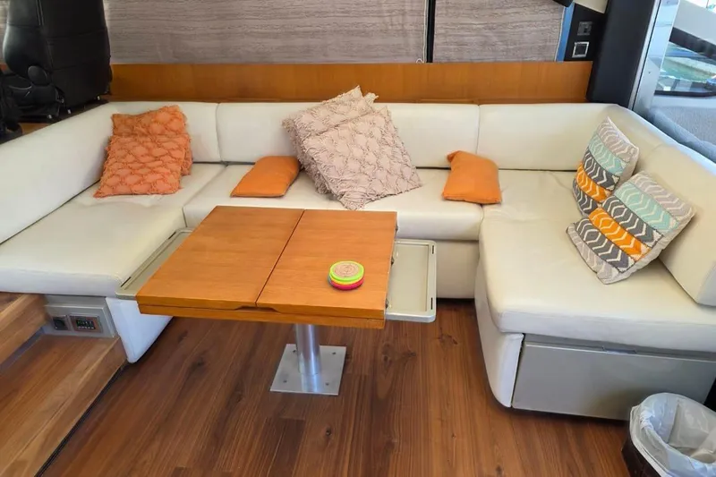  Yacht Photos Pics Luxurious interior of 2013 Fairline Targa 62 GT yacht with cozy seating and wooden table.