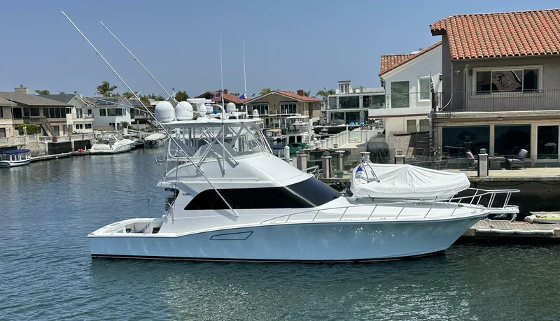 Off Season Yacht Photos Pics 2006 Cabo 48 Convertible yacht docked in a scenic marina setting.